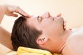 Man Receiving Forehead Massage In Spa