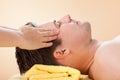 Man Receiving Forehead Massage In Spa