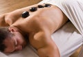 Man receiving hot stone therapy massage Royalty Free Stock Photo