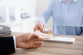 Man receiving money from teller at cash window, closeup Royalty Free Stock Photo