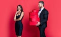 Man receiving present. Happy Valentines day. Couple in love isolated on red. Birthday couple with gift. Loving man Royalty Free Stock Photo