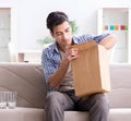 Man receiving wrong parcel with glasses