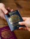 man recieving new post Brexit blue British passport with old European Union red one the table Devon, United Kingdom Royalty Free Stock Photo