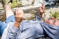 Man reclines on rocky terrain while meditating Royalty Free Stock Photo