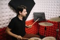 Man recording music on drum set in studio Royalty Free Stock Photo