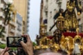 A man records with his mobile phone the Procession of Jesus the Nazarene in Huelva, Spain