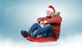 Man in red cap Santa Claus on a sledge Royalty Free Stock Photo