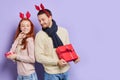 Man in red christmas horn holding Christmas tree