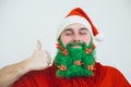 Man in red clothes with green beard show thumb up sign