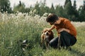 Man and red dog face to face in outdoors