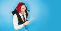 Man with red dreadlocks holding in hand sticks chopsticks with sushi roll traditional japanese food looking at camera Royalty Free Stock Photo