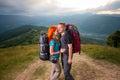 Man and red-haired woman on the road in the mountains Royalty Free Stock Photo