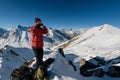 Man in a red jacket with snowboard near his legs Royalty Free Stock Photo