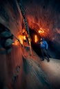 Man with red lamp in amazing blue ice cave Royalty Free Stock Photo