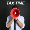 Man with red megaphone and text TAX TIME on background Royalty Free Stock Photo