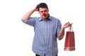 Man with a red nose funny holding a shopping bag gift present is Royalty Free Stock Photo