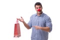 Man with a red nose funny holding a shopping bag gift present is Royalty Free Stock Photo