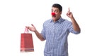 Man with a red nose funny holding a shopping bag gift present is Royalty Free Stock Photo