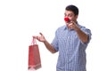 Man with a red nose funny holding a shopping bag gift present is Royalty Free Stock Photo