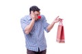 Man with a red nose funny holding a shopping bag gift present is Royalty Free Stock Photo