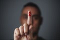 man with red ribbon for the fight against AIDS