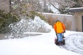 Man with Red Snow Blower Royalty Free Stock Photo