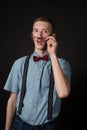 Man in a red suit and a bow tie plaid shirt on a black background Royalty Free Stock Photo