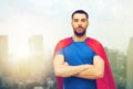 Man in red superhero cape over city background Royalty Free Stock Photo