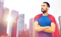 Man in red superhero cape over city skyscrapers Royalty Free Stock Photo