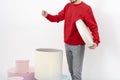 A man in a red sweatshirt takes out a gift box. birthday surprise. Christmas multicolored gift boxes on a white background.