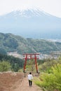 Man at red torii gate with Mt.Fuji view in Kawaguchi Asama Shrine Royalty Free Stock Photo