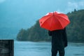 Man with red umbrella standing in the rain Royalty Free Stock Photo