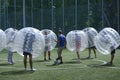 Man keeping ball in the center of a football field by his leg, before beginning of bubble football match. August 12, 2019. Kiev,