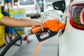 Man Refill and filling Oil Gas Fuel at station.Gas station - refueling.To fill the machine with fuel. Car fill with gasoline at a Royalty Free Stock Photo