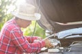 Man refill water to tank of car radiator and checking up the engine before start the trip. Car maintenance or check up concept Royalty Free Stock Photo