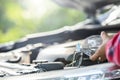 Man refill water to tank of car windshield wiper and checking up the engine before start the trip. Car maintenance or check up Royalty Free Stock Photo