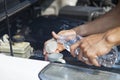 Man refilling wiper tank Royalty Free Stock Photo