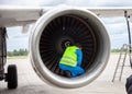 A man in a reflective vest. Technician sits in a turbine and checks the plane`s engine before flying. Aviation maintenance, repai