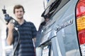 Man Refueling Blurred Hybrid Car