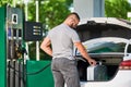 Young man refueling canister with fuel.