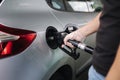 Man is refueling at gas station. Male hand filling benzine gasoline fuel in car using a fuel nozzle. Petrol prices Royalty Free Stock Photo