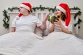 A man refuses a gift on a bed decorated for Christmas on New Year Ev