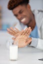 man refusing glass milk at home