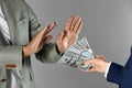 Man refusing to take bribe on grey background, closeup of hands Royalty Free Stock Photo