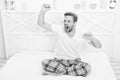 Man relax in bed. perfect morning. yawn and stretch in the morning. feeling cosy and comfortable. Menswear pajamas Royalty Free Stock Photo