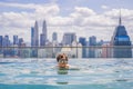 Man relax in swimming pool in sunrise, on rooftop in the city. Rich people