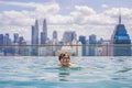 Man relax in swimming pool in sunrise, on rooftop in the city. Rich people