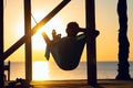 Man relaxes in a hammock on abandoned bungalow veranda