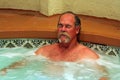 Man relaxes in jacuzzi spa Royalty Free Stock Photo