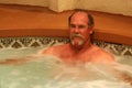 Man relaxes in jacuzzi spa